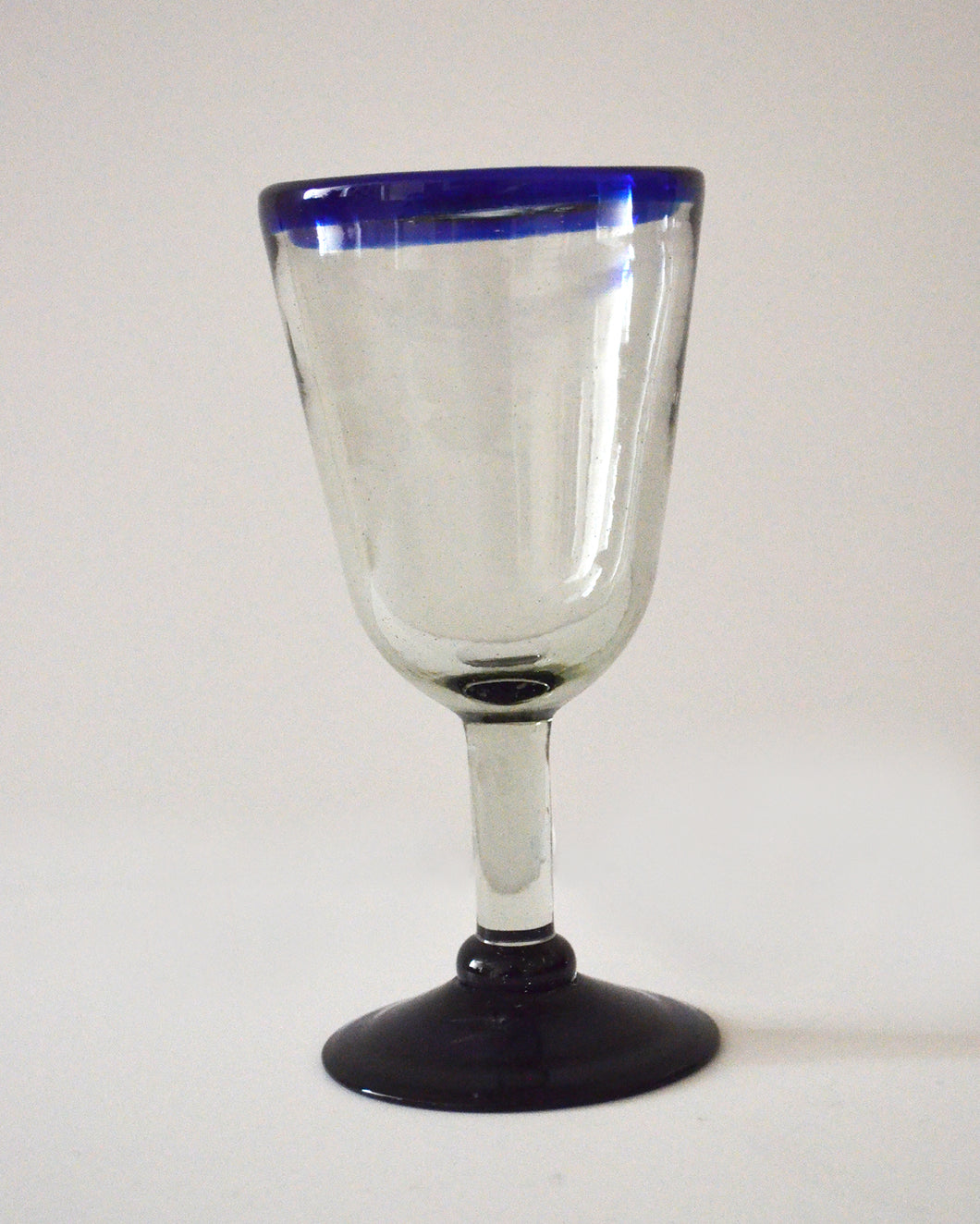 Hand blown wine glass with a blue rim