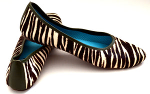 Mom and daughter zebra print shoes.